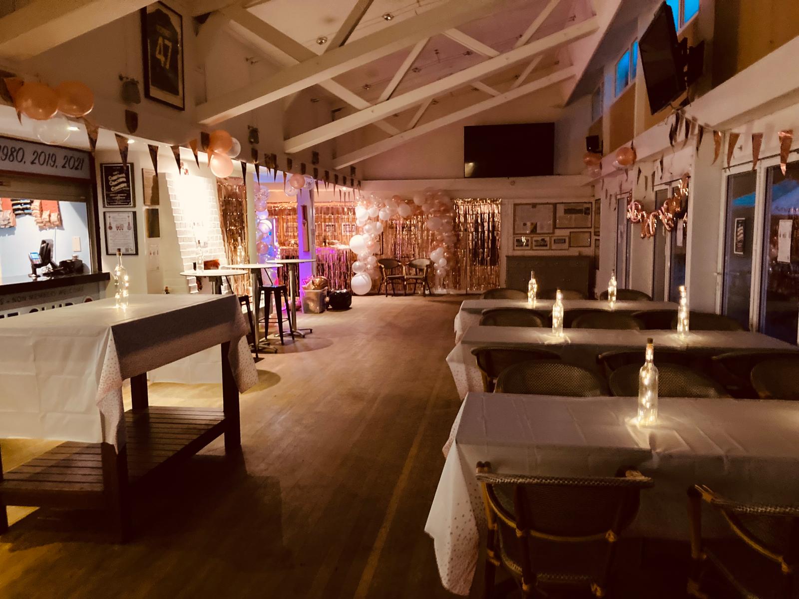 The clubhouse set for a candlelit supper with soft lighting