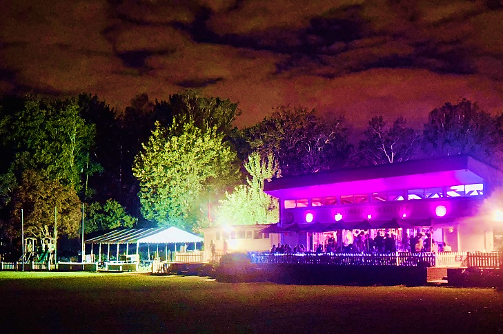 The pavilion and marquee illuminated for an evening event