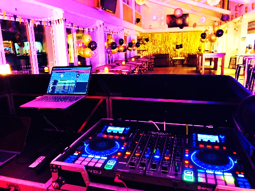 DJ setup with laptop and controllers