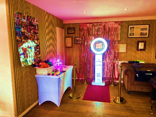 Photo booth with pink tinsel backdrop