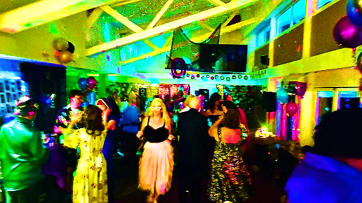 Guests dancing under colourful lights
