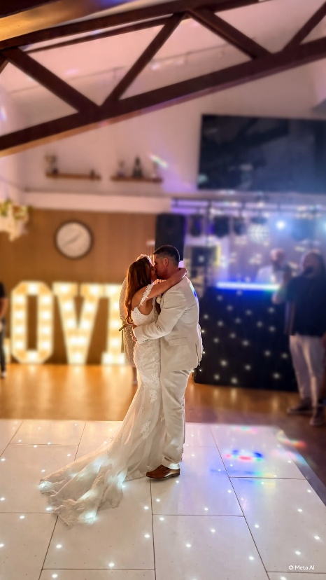 Newlyweds dancing beneath illuminated love letters