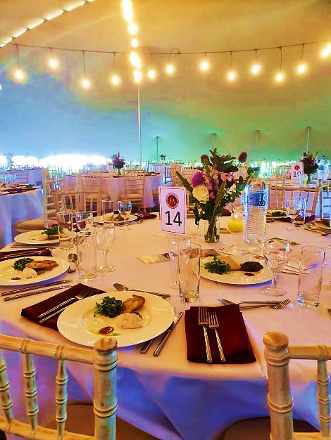 Elegant dining tables beneath warm festoon lights