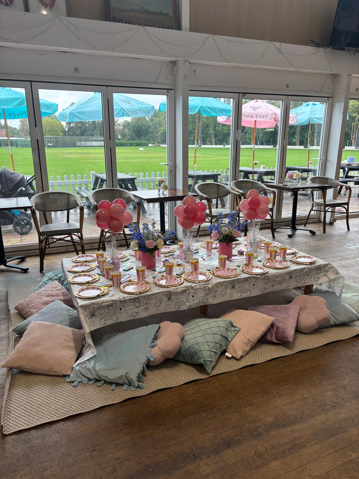 A children's low floor table party setup with cushions in the clubhouse