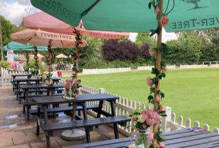 Decorated terrace tables overlooking the cricket ground