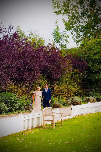 Wedding couple beside the white boundary fence