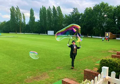 Bubble entertainer delighting children on the cricket ground